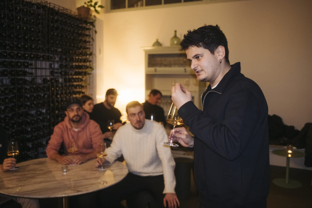 Junus spricht vor Gruppe bei einem Vinum Voyage Event
